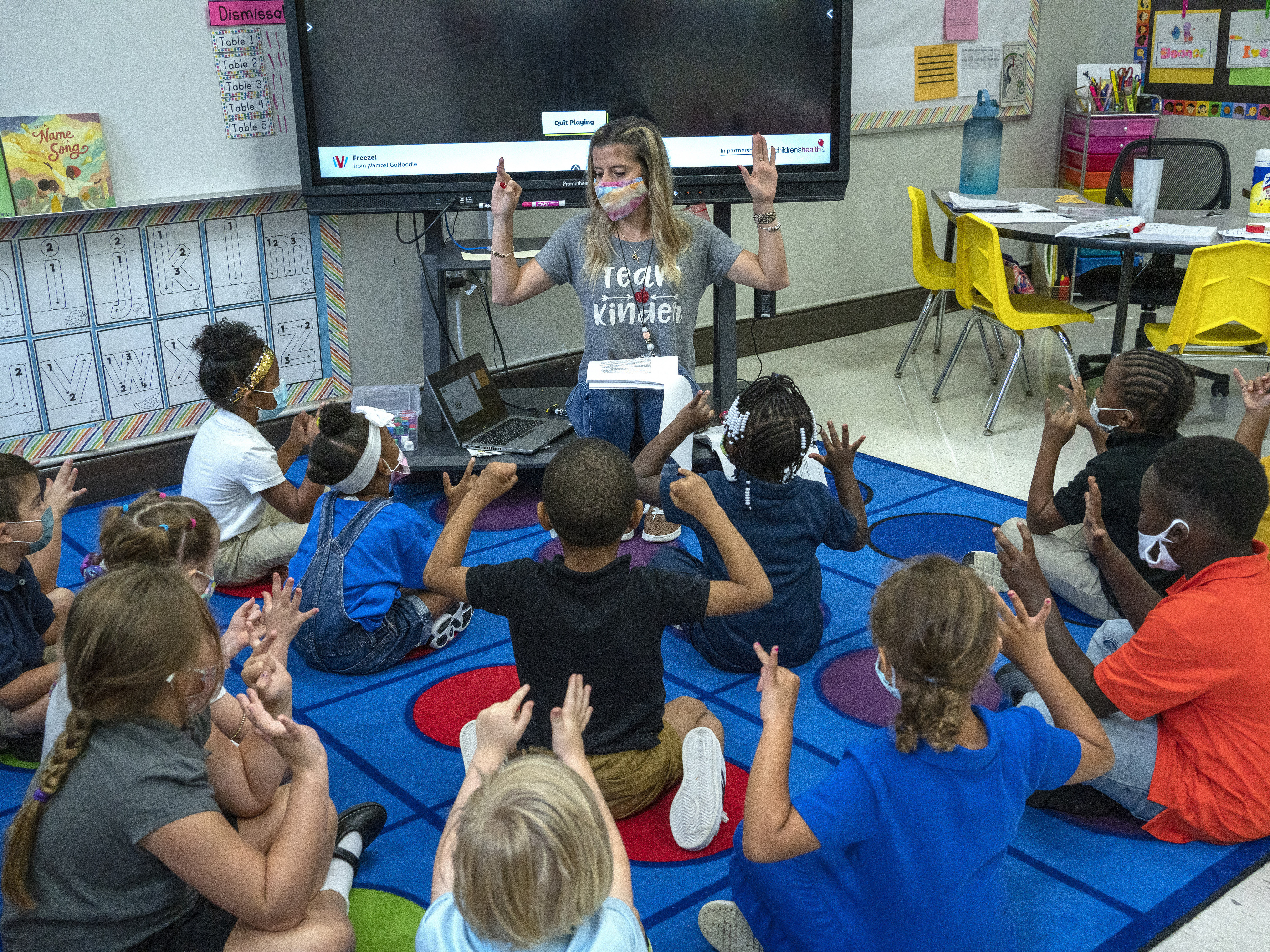 caption: Nashville kindergarten teacher Amber Updegrove leads her class in a lesson earlier this month. On Monday, the U.S. Education Department announced an investigation into Tennessee's requirement that schools allow families to opt out of mask mandates.