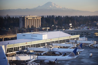 caption: The A concourse at Seattle-Tacoma International Airport in front of Mt. Rainier in December 2017. 