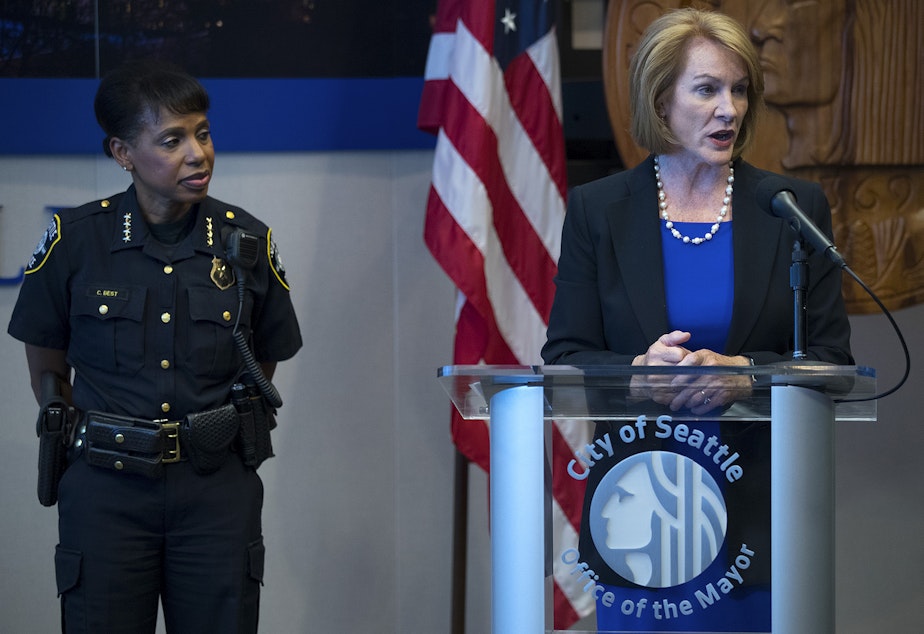 caption: FILE: Seattle Mayor Jenny Durkan stands with Carmen Best as she answers questions from the press on Tuesday, July 17, 2018, at City Hall in Seattle. 