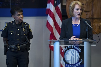 caption: FILE: Seattle Mayor Jenny Durkan stands with Carmen Best as she answers questions from the press on Tuesday, July 17, 2018, at City Hall in Seattle. 