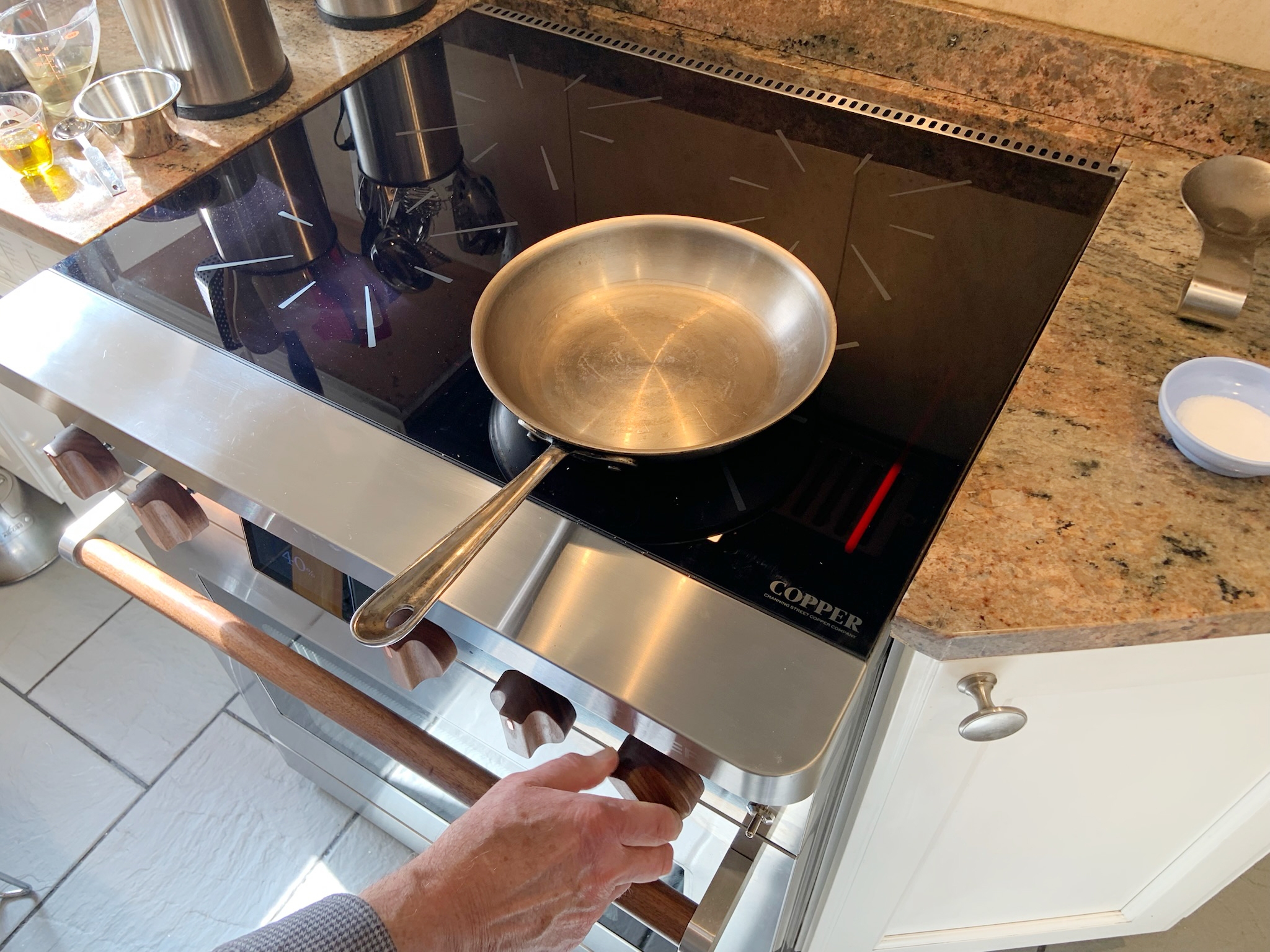 caption: The Copper induction stove has a battery under the oven, so the appliance can plug into a regular household outlet.