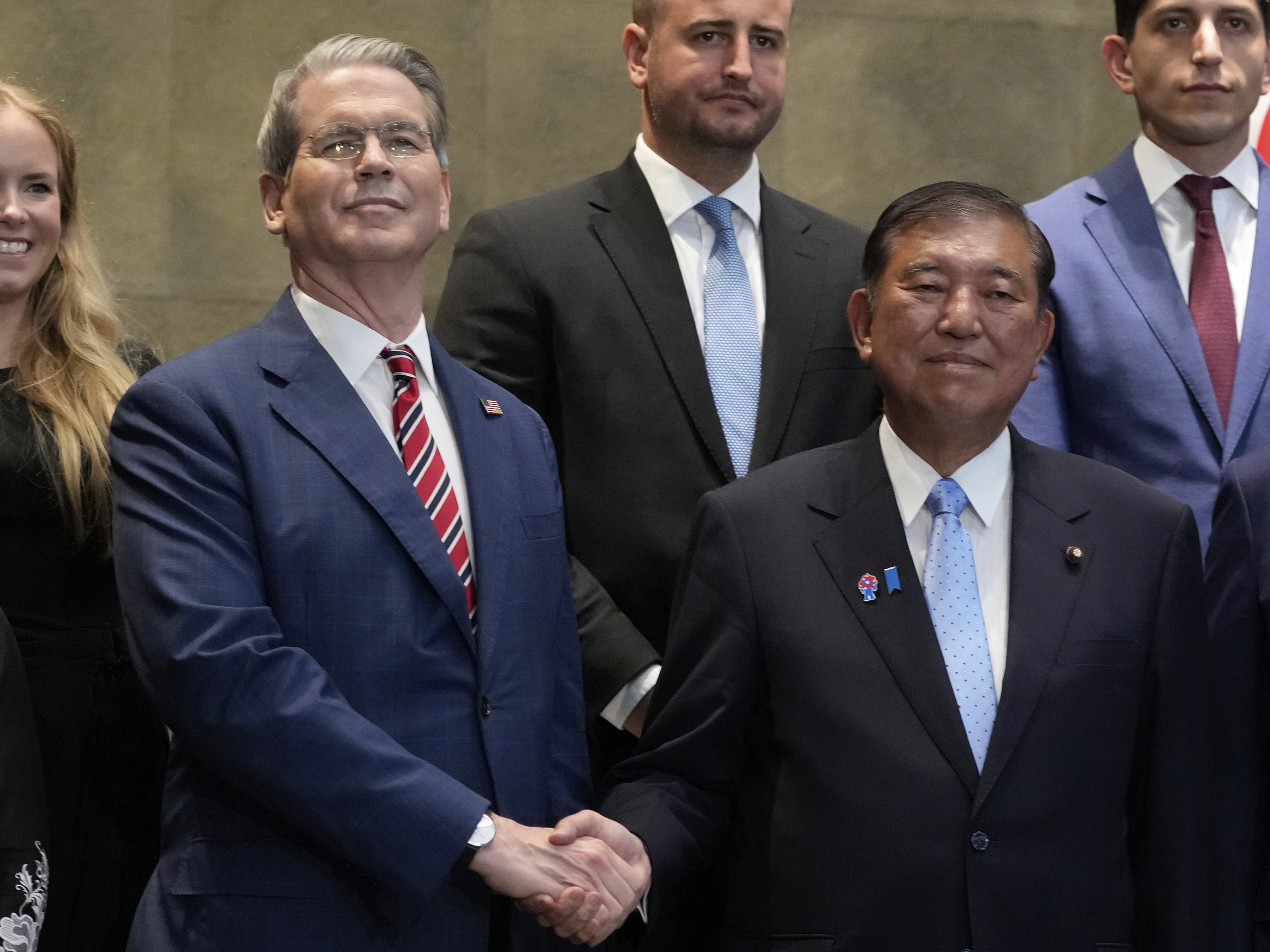 caption: Japanese Prime Minister Shigeru Ishiba, right, shakes hands with U.S. Treasury Secretary Scott Bessent before their meeting at the prime minister's office in Tokyo on July 18, 2025.
