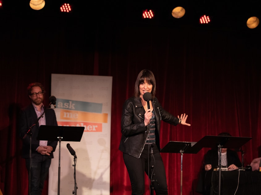 caption: Ophira Eisenberg performs stand-up on <em>Ask Me Another</em> at the Bell House in Brooklyn, New York.