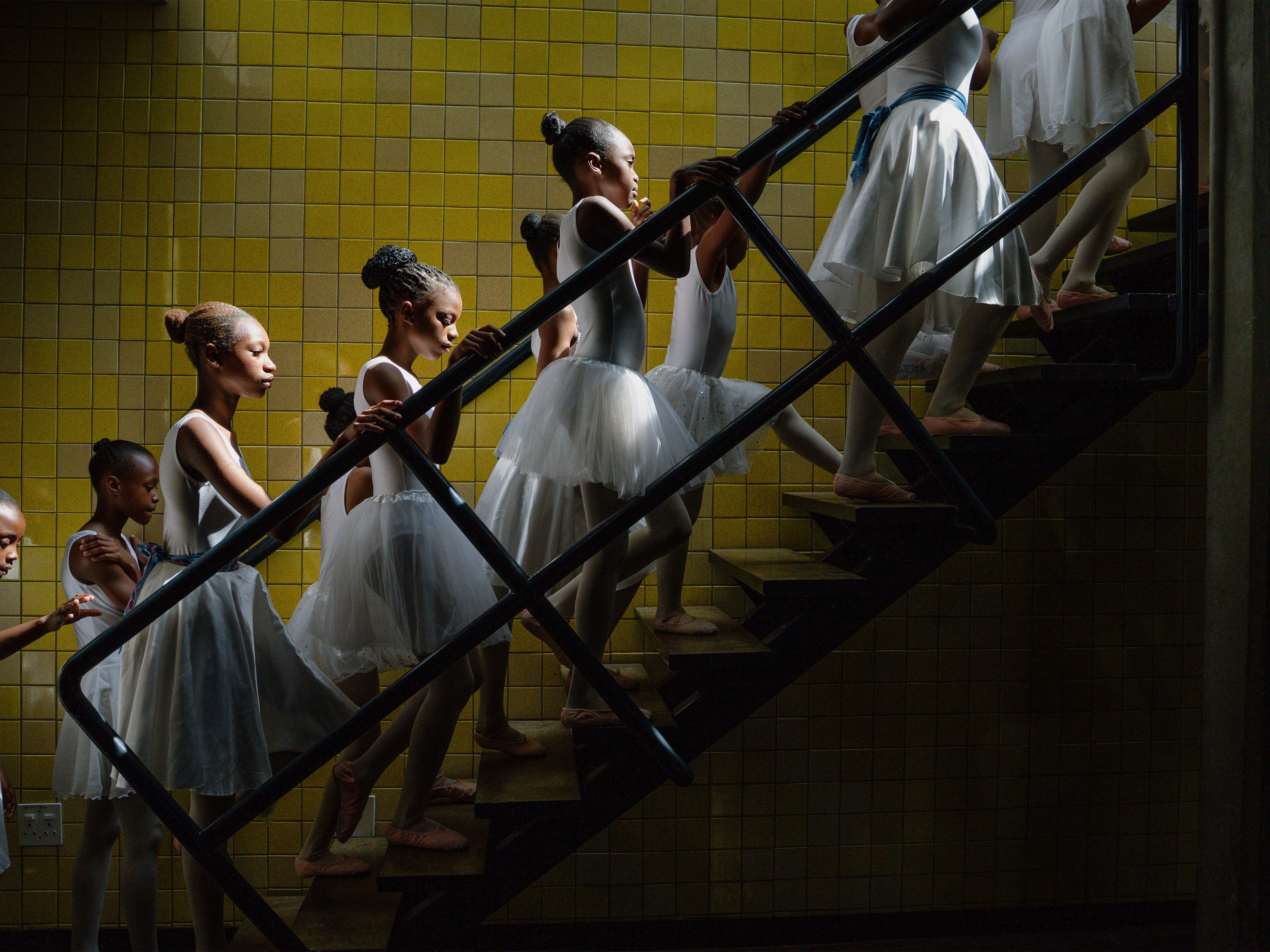 caption: Young dancers from the Joburg Ballet School backstage at the Soweto Theatre prepare for their year-end performance. Soweto, South Africa. December 7, 2025.