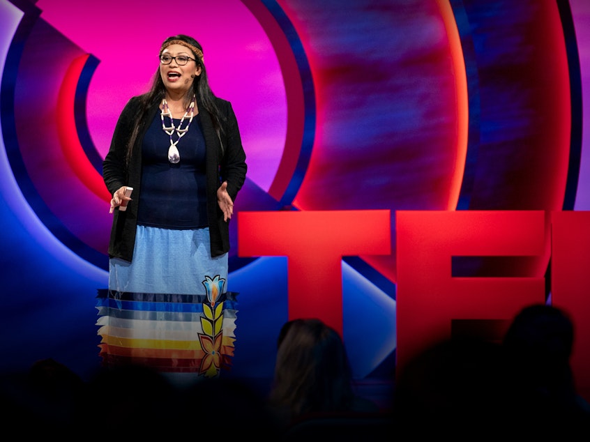 caption: Kelsey Leonard speaks from the TED stage.