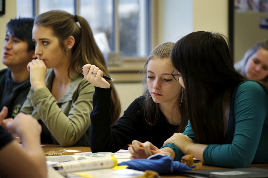 caption: In this photo taken Nov. 23, 2015, sophomores Kendra Mitchell, second left, and Katie Benmar, sit with other first-period students in a geography class at Roosevelt High School in Seattle. 
