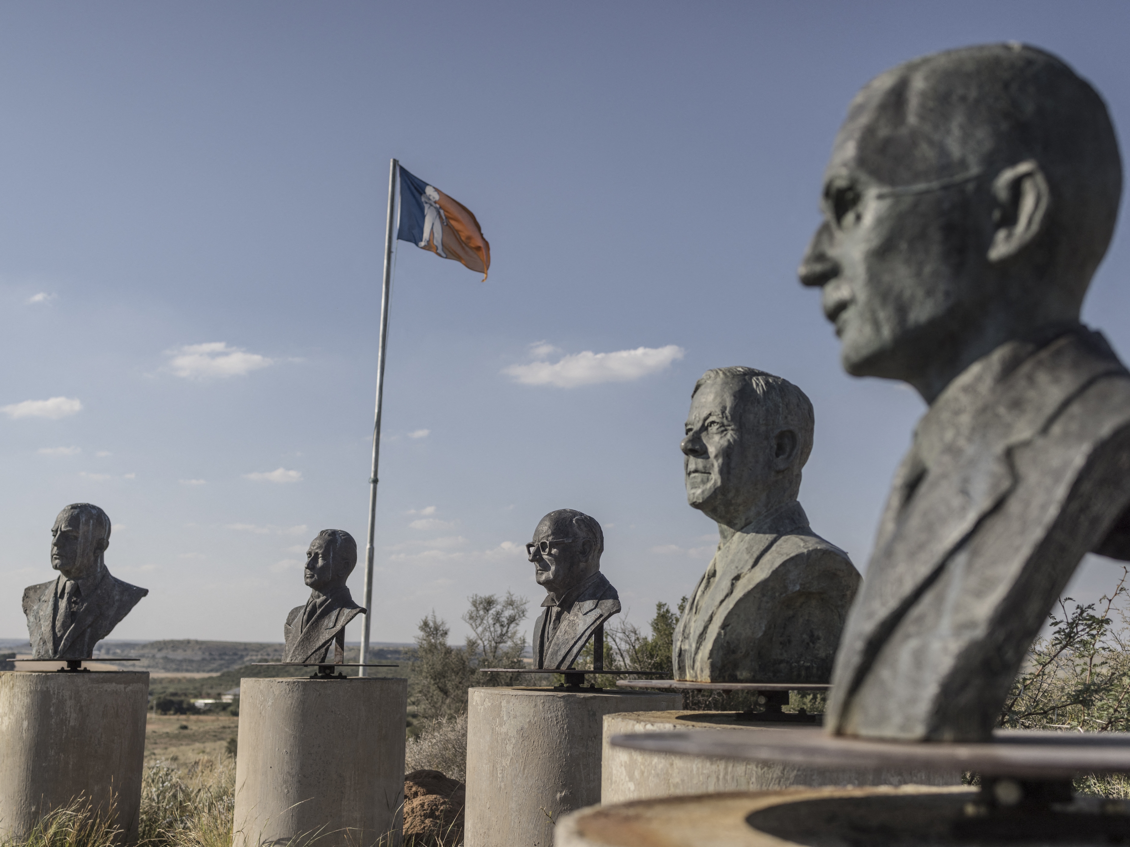 caption: Bronze busts of past Afrikaner leaders are seen on a hill in Orania, South Africa, in 2024.