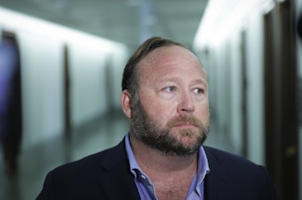 caption: Conspiracy theorist Alex Jones, seen here in 2018, and his network of websites have been banned from most major online and social media platforms but have still managed to bring in tens of millions of dollars in revenue.