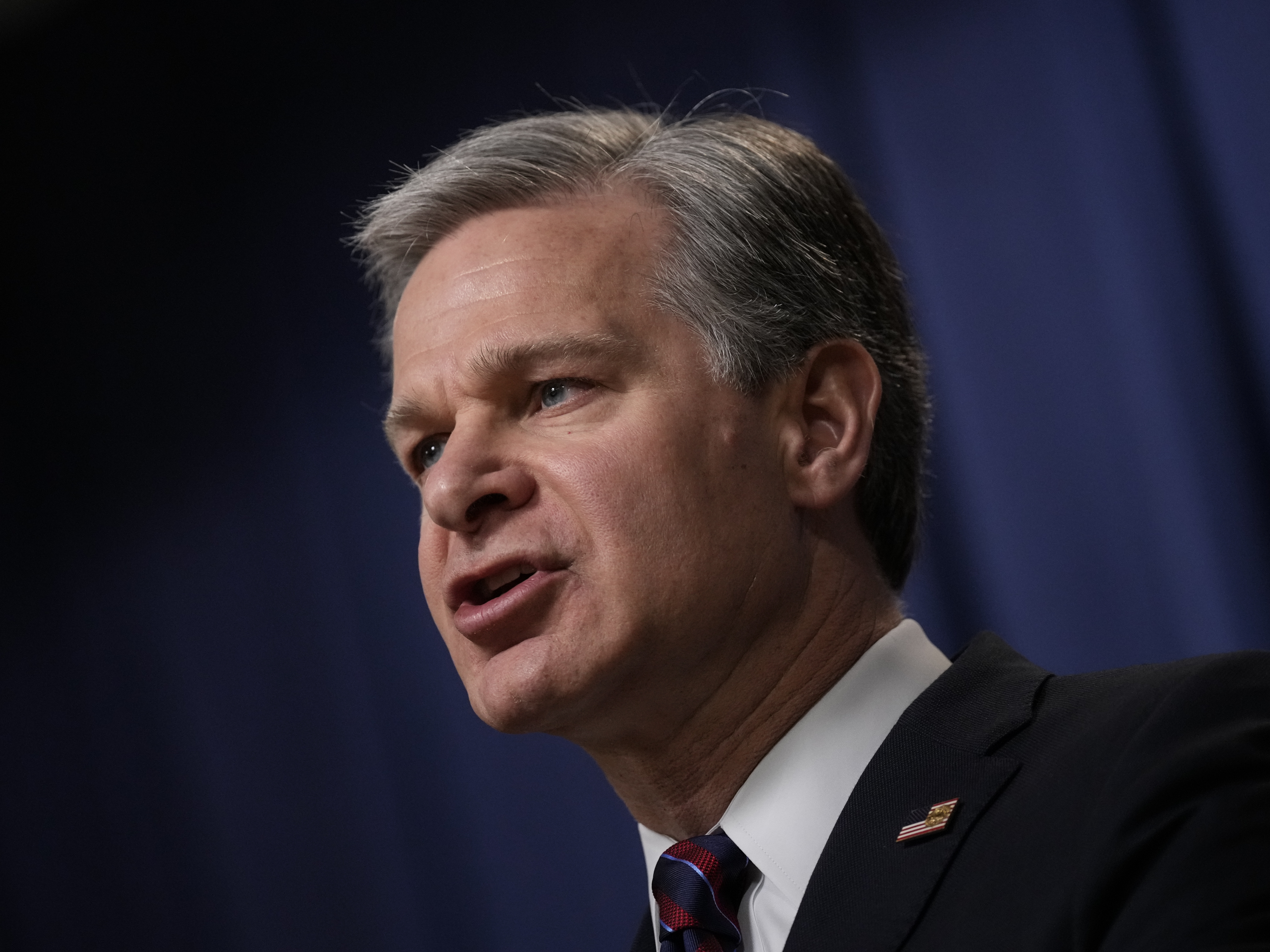 caption: FBI Director Christopher Wray speaks during a news conference in 2023.