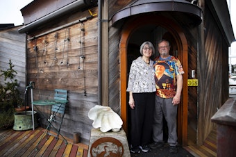 caption: Janet Yoder and Robert Rudine are portrayed on their houseboat, the self-declared sovereign nation of Tui Tui, on Tuesday, March 26, 2024, in Seattle. 