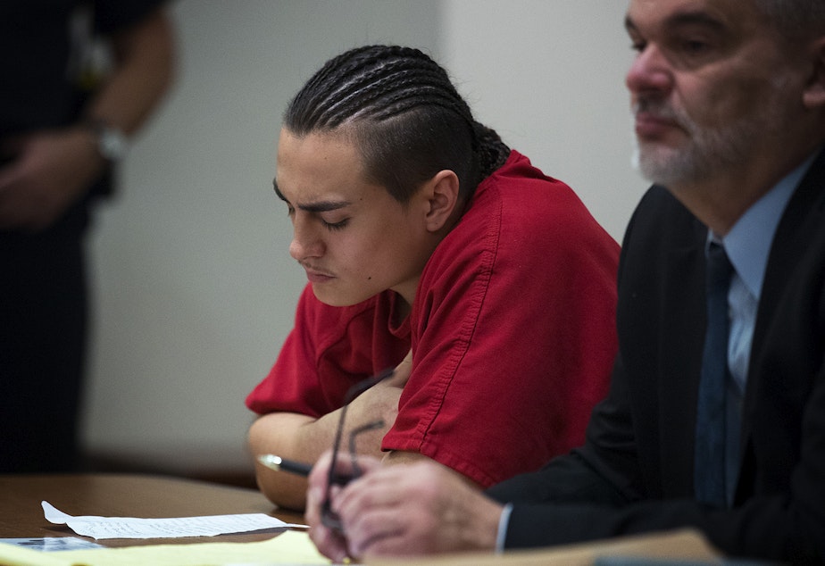 caption: Julian Tuimauga, left, listens as the video that that he took immediately after the beating plays for the judge, with his defense attorney Robert Huff on Friday, November 16, 2018, during his sentencing at the Maleng Regional Justice Center in Kent. 