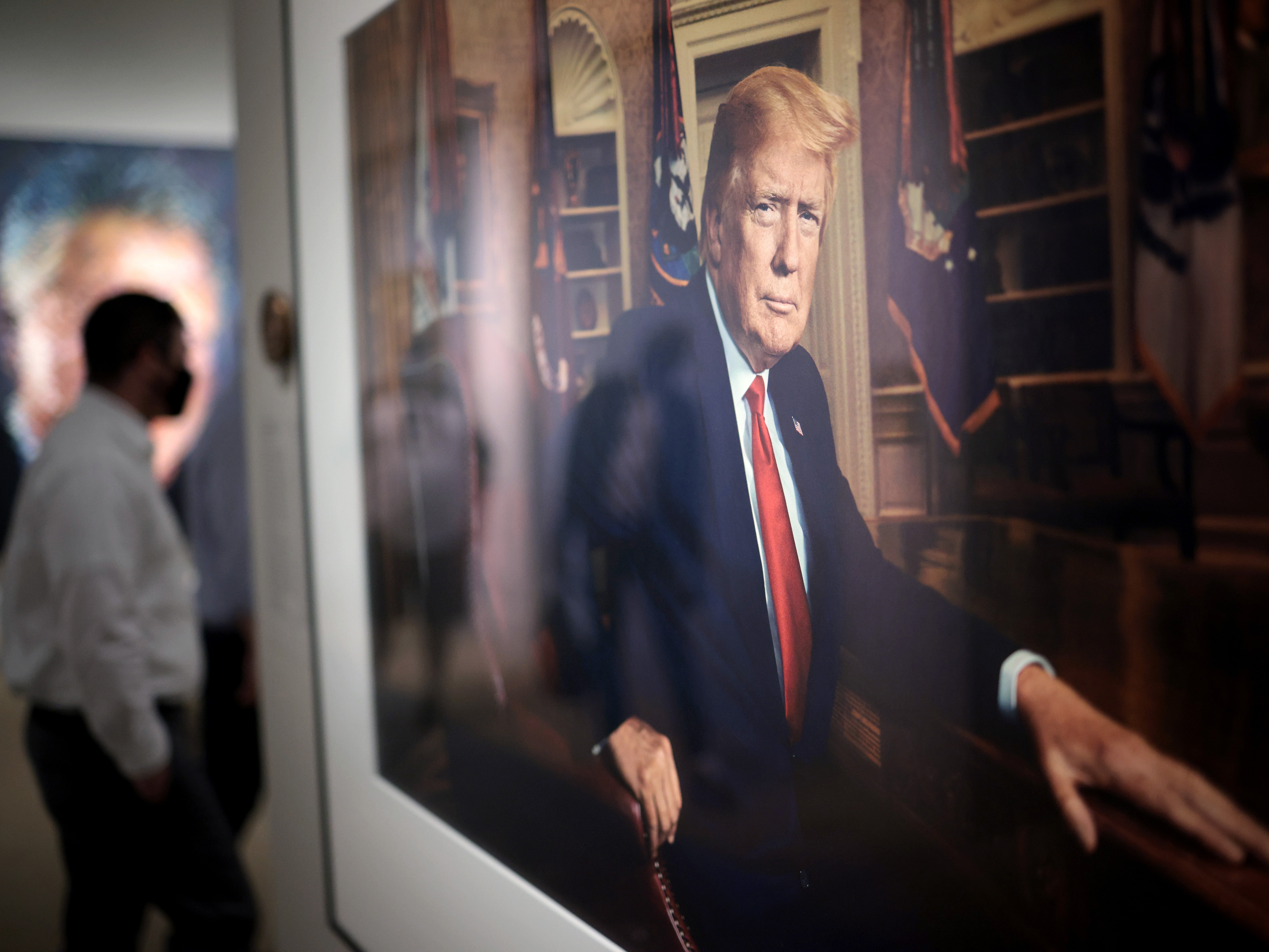 caption: Patrons view a portrait of President Trump in the America's Presidents exhibition at the National Portrait Gallery on May 14, 2021 in Washington, DC.