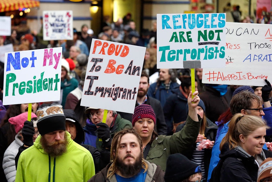 caption: FILE: People begin to gather before a rally protesting President Donald Trump's travel ban on refugees and citizens of seven Muslim-majority nations, Sunday, Jan. 29, 2017, in Seattle.