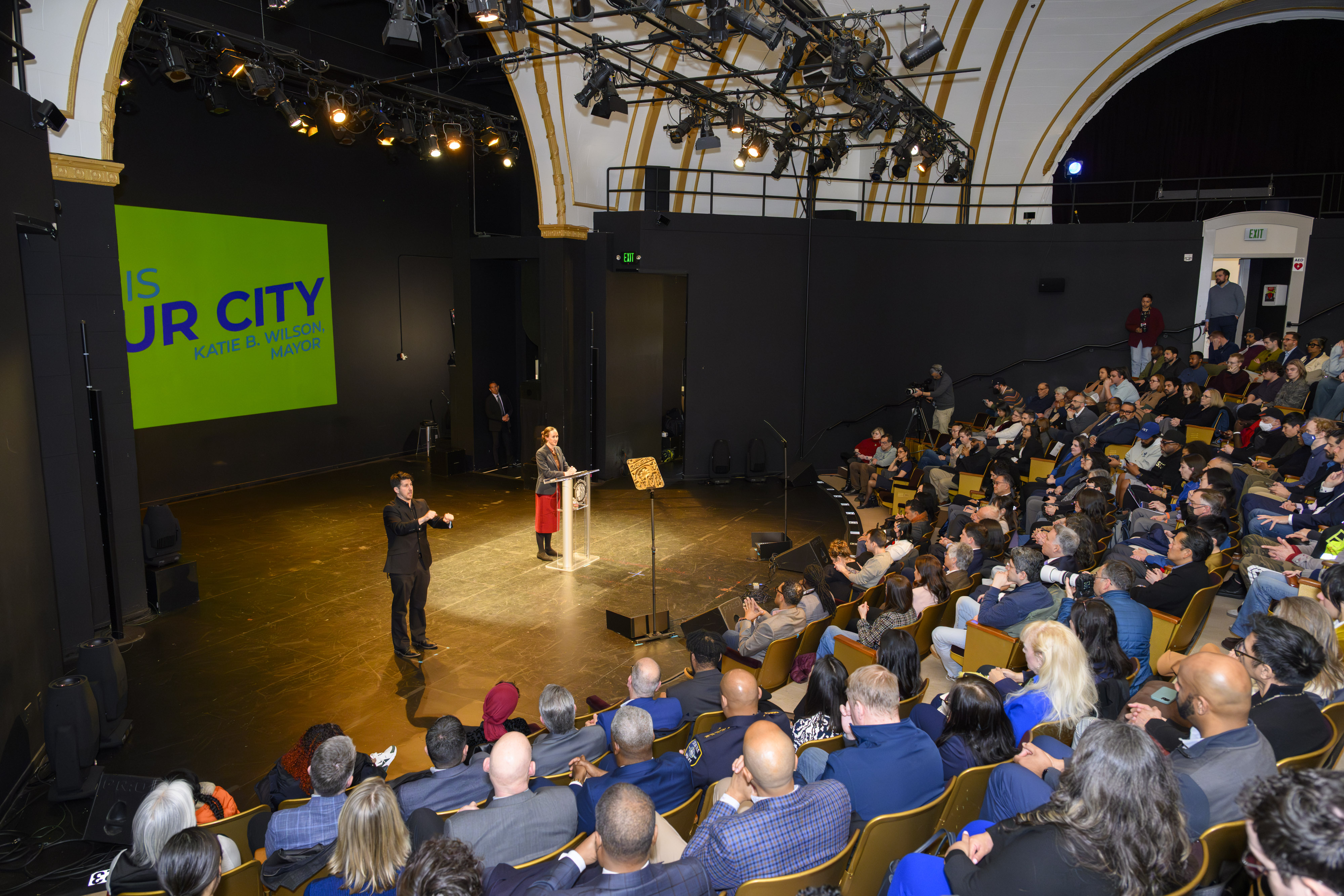 caption: Seattle Mayor Katie Wilson addresses a crowd of elected officials and supporters at Langston Hughes Performing Arts Institute on Feb. 17, 2026.