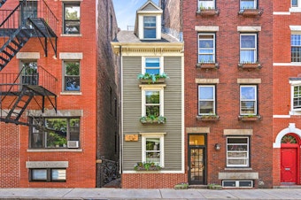 caption: The "Skinny House" or the "Spite House" is 10 feet wide at its widest. It's been sold for $1.25 million.