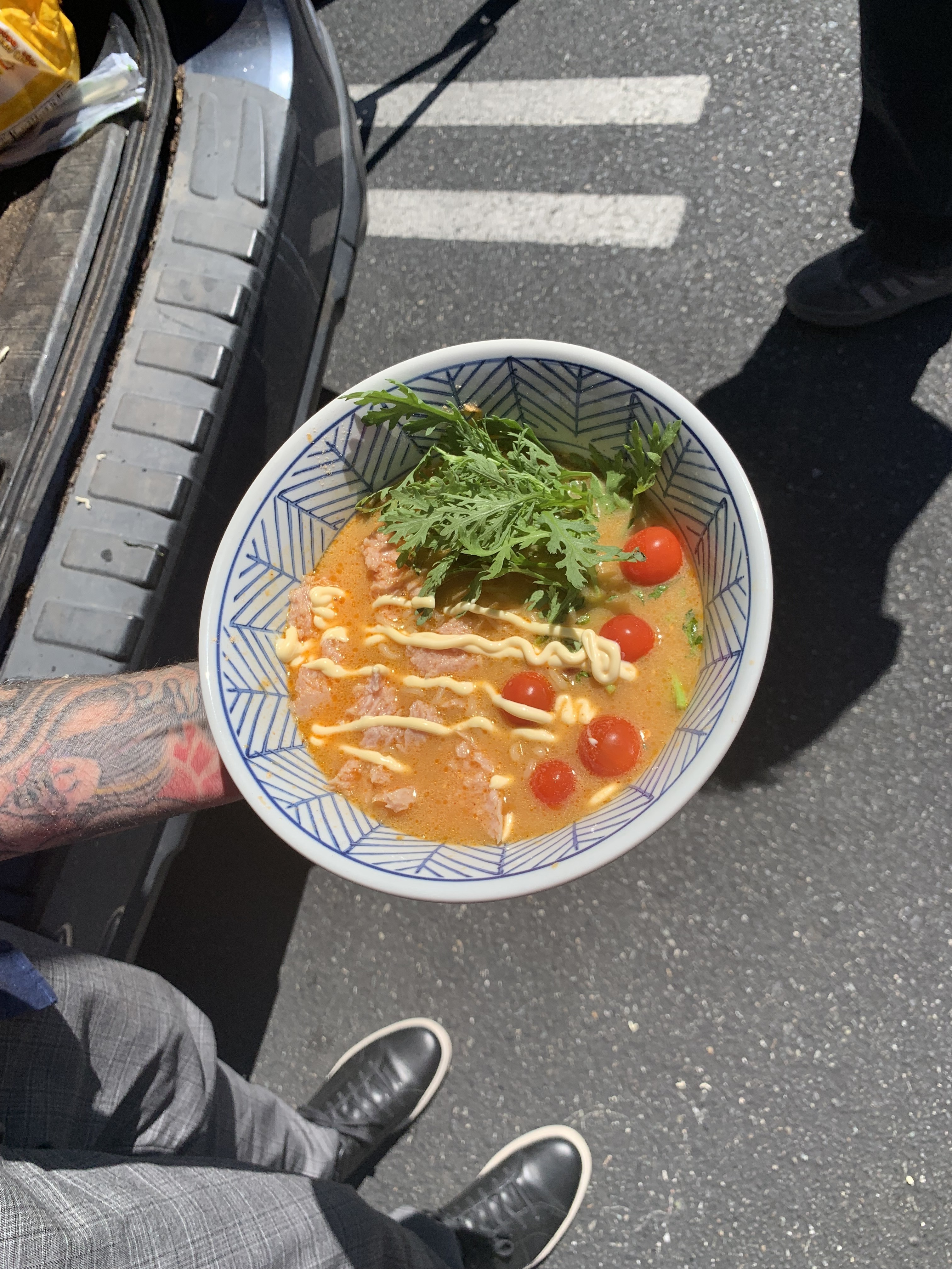 caption: Cheese ramen with Spam, chrysanthemum greens, cherry tomatoes and kewpie mayo.