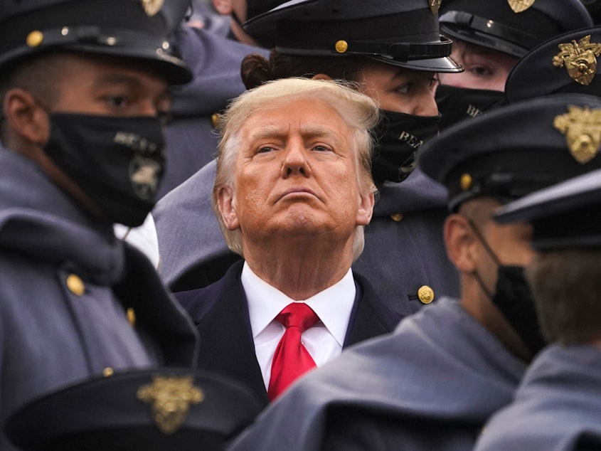 caption: Surrounded by Army cadets, President Trump watches the Army-Navy football game at the U.S. Military Academy in West Point, N.Y., on Dec. 12.