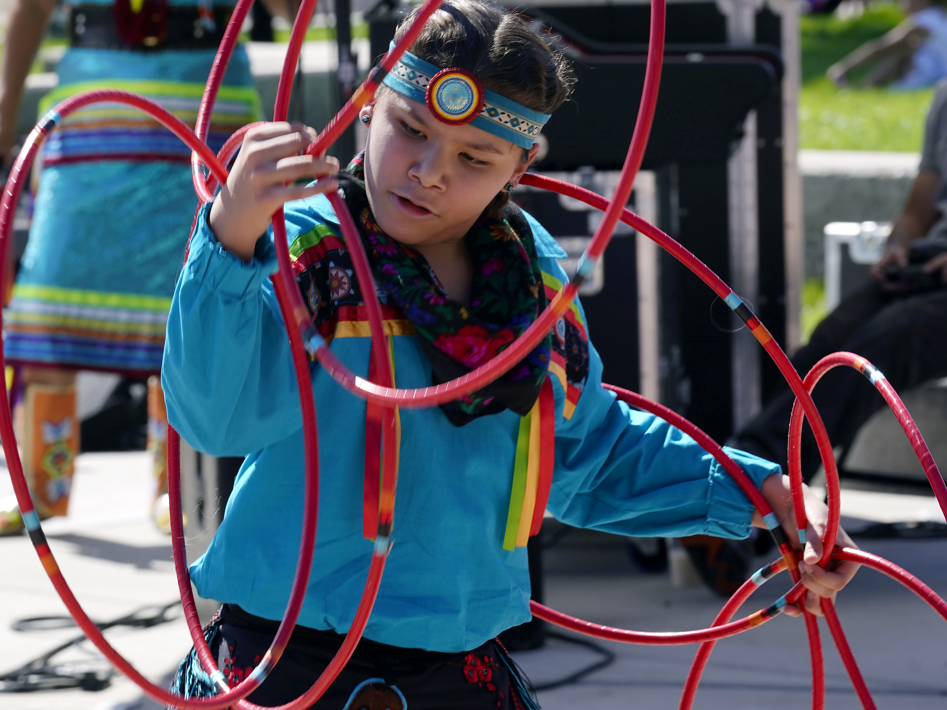 caption: A performer from the Native American Hoop Dance of Ballet Arizona dances at an Indigenous Peoples Day festival Monday, Oct. 9, 2023, in Phoenix.