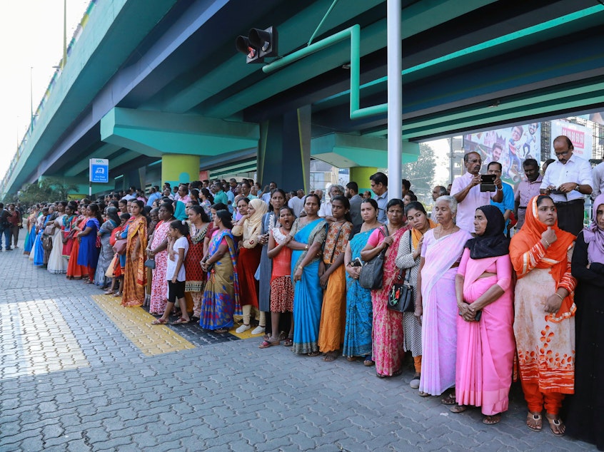 caption: Millions of women joined hands along a highway in Kerala to form a "women's wall" on January 1. For participants, the goal is gender equality.