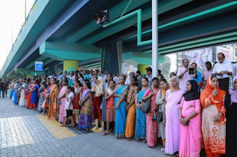 caption: Millions of women joined hands along a highway in Kerala to form a "women's wall" on January 1. For participants, the goal is gender equality.