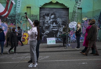 caption: A mural of George Floyd is displayed behind the Interfaith Chaplain station at the Capitol Hill Autonomous Zone, CHAZ, or Capitol Hill Occupied Protest, CHOP, on Saturday, June 13, 2020, in Seattle.