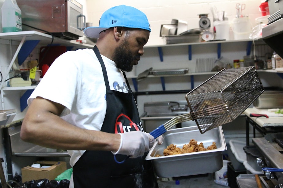 caption: Jimaine Miller prepares chicken tenderloin for po'boy sandwiches in the kitchen of Soulful Dishes on Yesler Way in Seattle. On the day KUOW visited, he was cooking for protesters in a south Seattle march, protesters at the CHOP, and a last minute paid event at the City of Seattle.