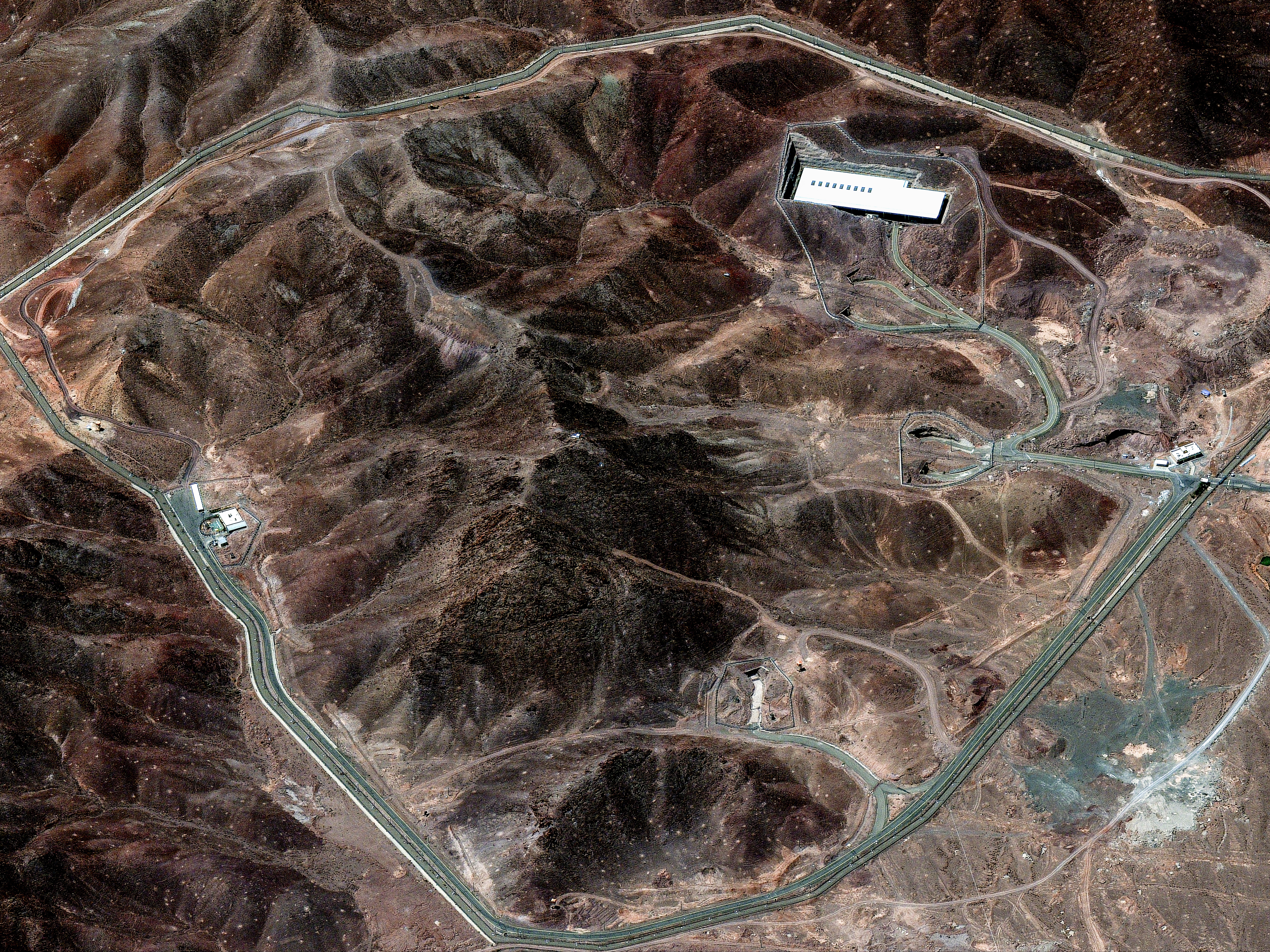 caption: Iran's Fordow Fuel Enrichment Plant is built into a mountainside and seems to be in the business of processing uranium isotopes.