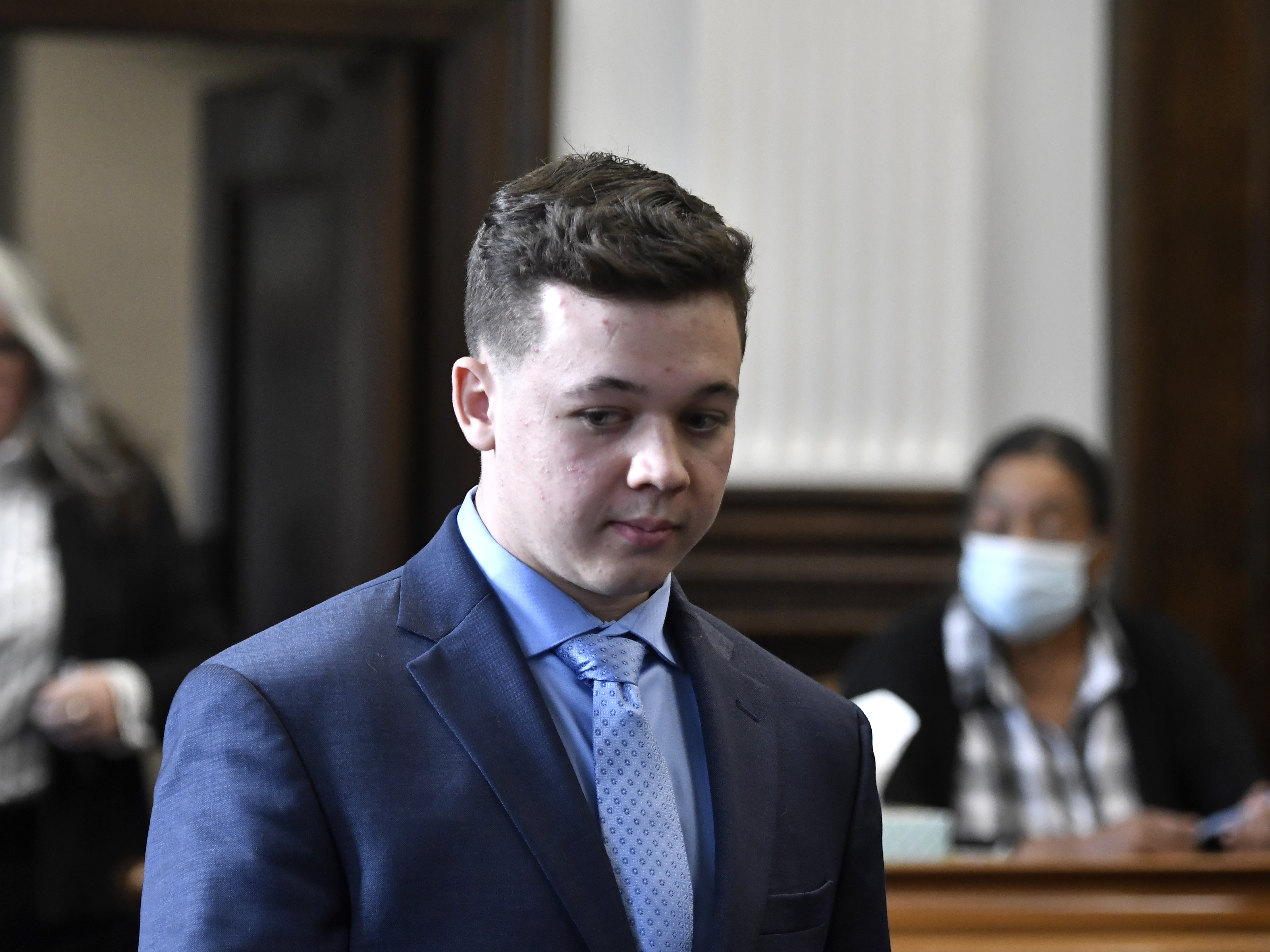 caption: Kyle Rittenhouse pictured during a motion hearing at the Kenosha County Courthouse on Monday.