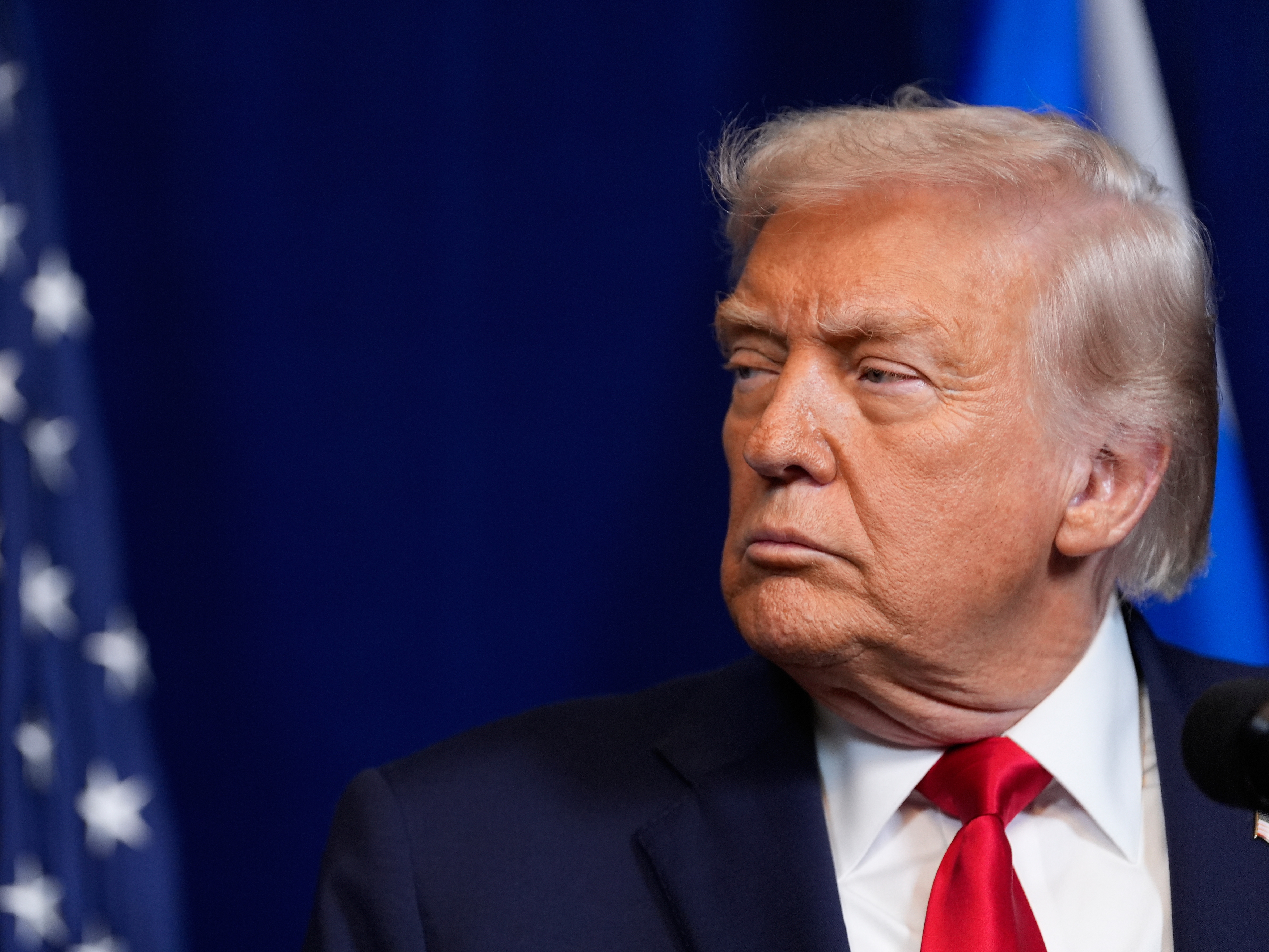 caption: President Trump listens during a news conference with Israel's Prime Minister Benjamin Netanyahu at Mar-a-Lago on Monday in Palm Beach, Fla.
