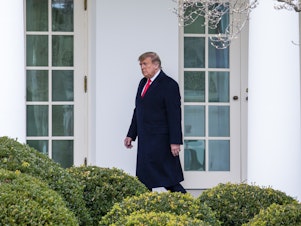 caption: WASHINGTON, DC - DECEMBER 31: U.S. President Donald Trump walks to the Oval Office while arriving back at the White House on December 31, 2020 in Washington, DC.