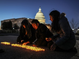 caption: Activists light candles outside the U.S. Capitol on Wednesday to commemorate the 20th anniversary of the U.S. invasion that launched the Iraq War in 2003.