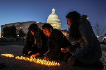 caption: Activists light candles outside the U.S. Capitol on Wednesday to commemorate the 20th anniversary of the U.S. invasion that launched the Iraq War in 2003.