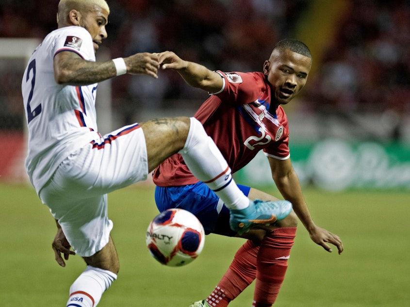 caption: Costa Rica's Ian Lawrence (right) vies for the ball with U.S. player DeAndre Yedlin during their FIFA World Cup Qatar 2022 CONCACAF qualifier match in San Jose, Costa Rica, on Wednesday.