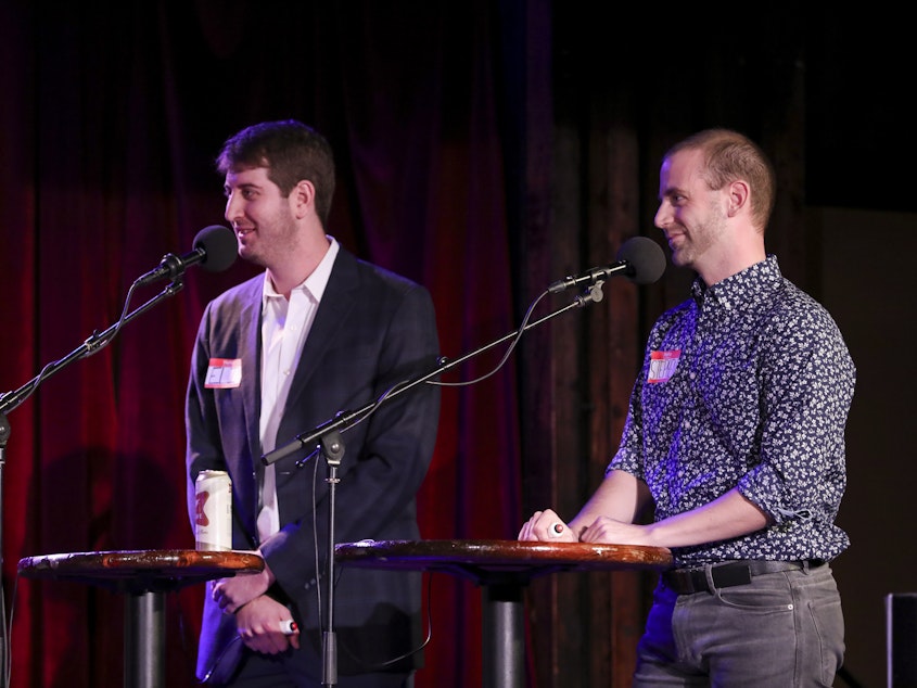 caption: Contestants Eli Robinson and Stephen Powell appear on <em>Ask Me Another</em> at the Bell House in Brooklyn, New York.