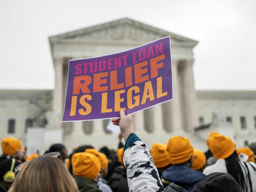 caption: Activists and students protest in front of the Supreme Court during a rally for student debt cancellation in Washington, D.C., in February 2023.