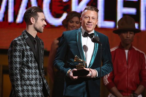 caption: Ryan Lewis, left, and Macklemore accept the award for best new artist at the 2014 Grammy Awards.