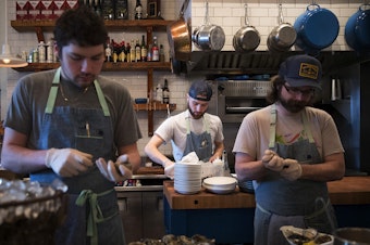 caption: From left, Damian Bogas, Evan Potter and Keegan Obrien work on Sunday, March 4, 2018, at the Walrus and the Carpenter in Seattle. 