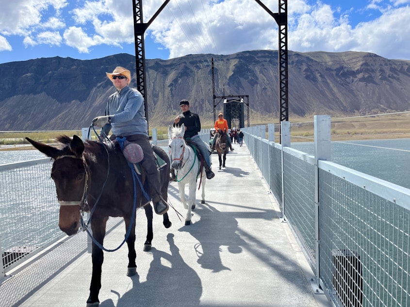 caption: Riders cross the newly rebuilt Beverly Bridge on the Palouse to Cascades State Park Trail after a well-attended dedication event on April 8, 2022.
