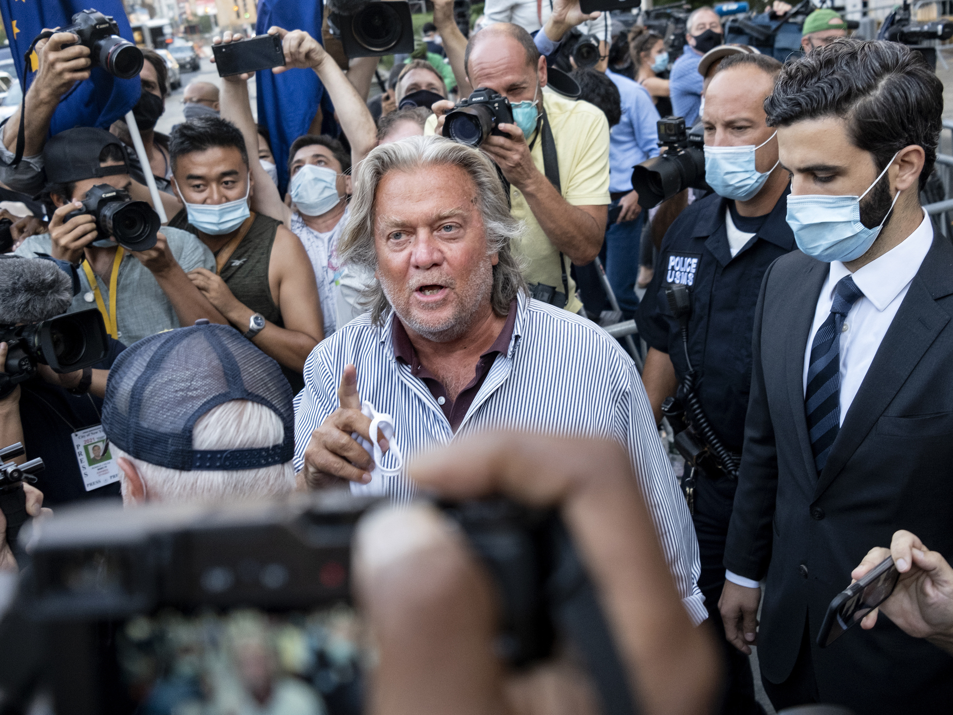 caption: Steve Bannon leaves federal court on Aug. 20 after pleading not guilty to charges he defrauded donors to an online fundraising scheme to build a southern border wall.