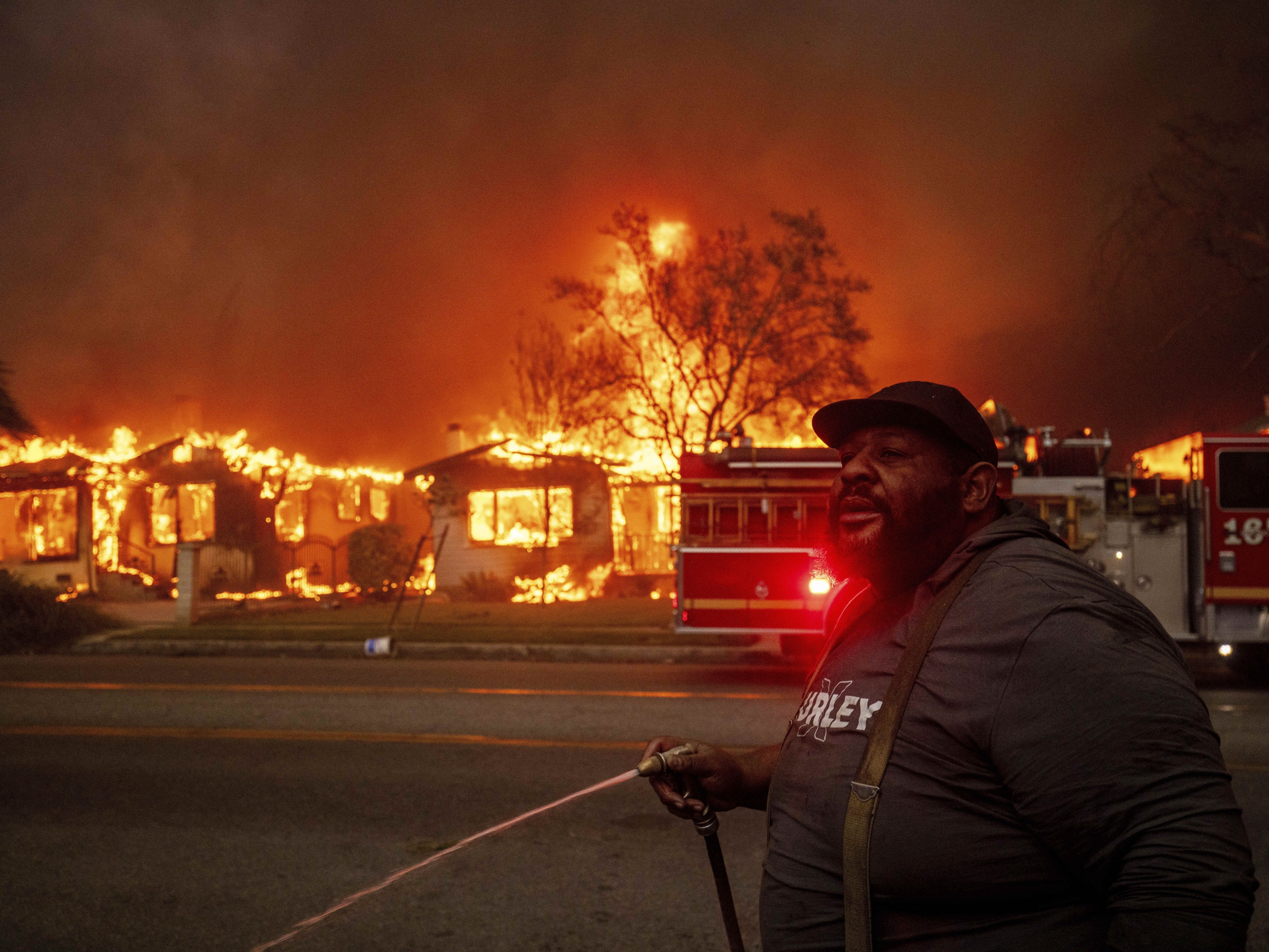 caption: A resident of Altadena, Calif., during wildfires in January 2025. Wildfires are getting more extreme because of climate change. The Trump administration has taken down the website for the National Climate Assessment, which is the most comprehensive and authoritative source of information about how climate change is affecting all parts of the U.S.