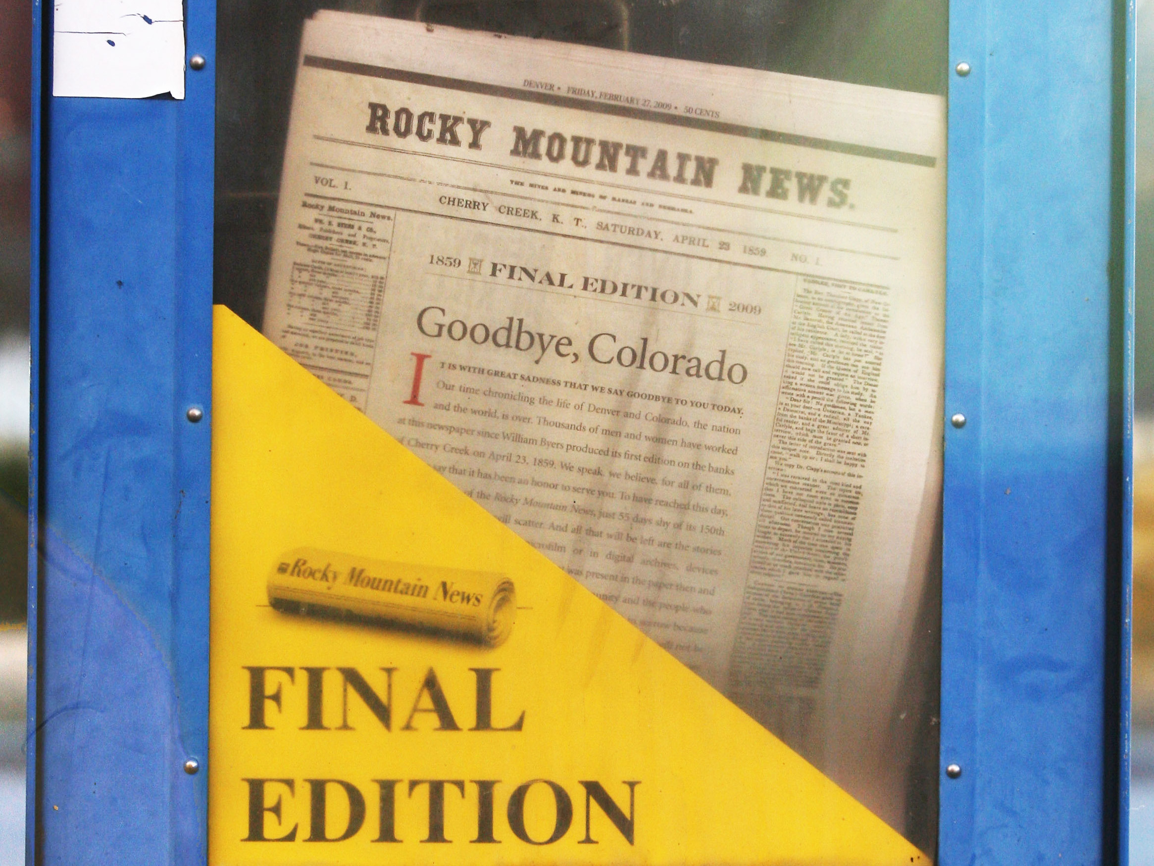 caption: A copy of the final edition of the Rocky Mountain News sits in a newspaper box on a street corner in Denver, Colorado.