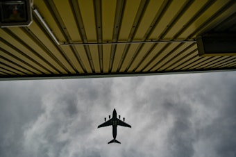 caption: A plane flies over temporary camp for refugees from Afghanistan at the U.S. Army's Rhine Ordnance Barracks (ROB), where they are being temporarily housed, on August 30, 2021 in Kaiserslautern, Germany.