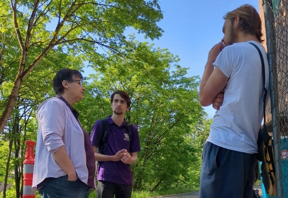 caption: University of Washington president Ana Mari Cauce (left) meets with student protesters outside the university's steam plant on May 20.
