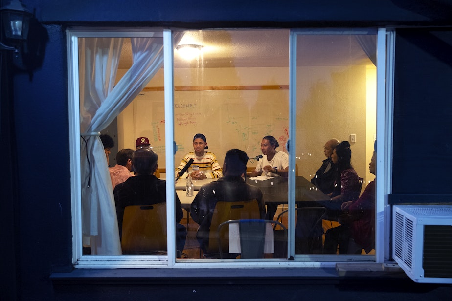 caption: Bunthay Cheam, center right, leads a dinner party conversation on Thursday, Oct. 6, 2022, in South Park. 