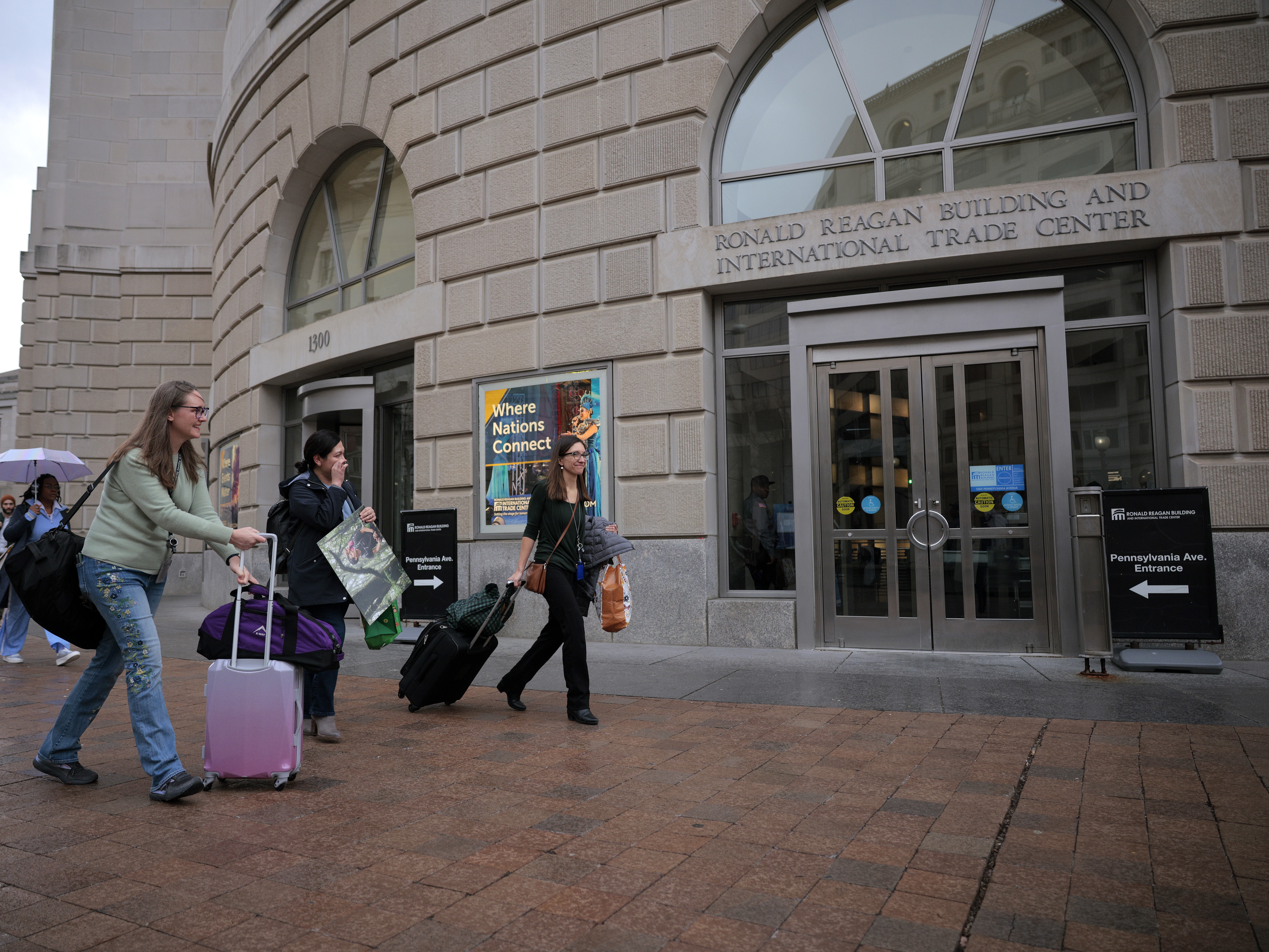 caption: Former U.S. Agency for International Development employees terminated after the Trump administration effectively dismantled the agency collect their personal belongings at USAID headquarters on Feb. 27 in Washington, D.C.