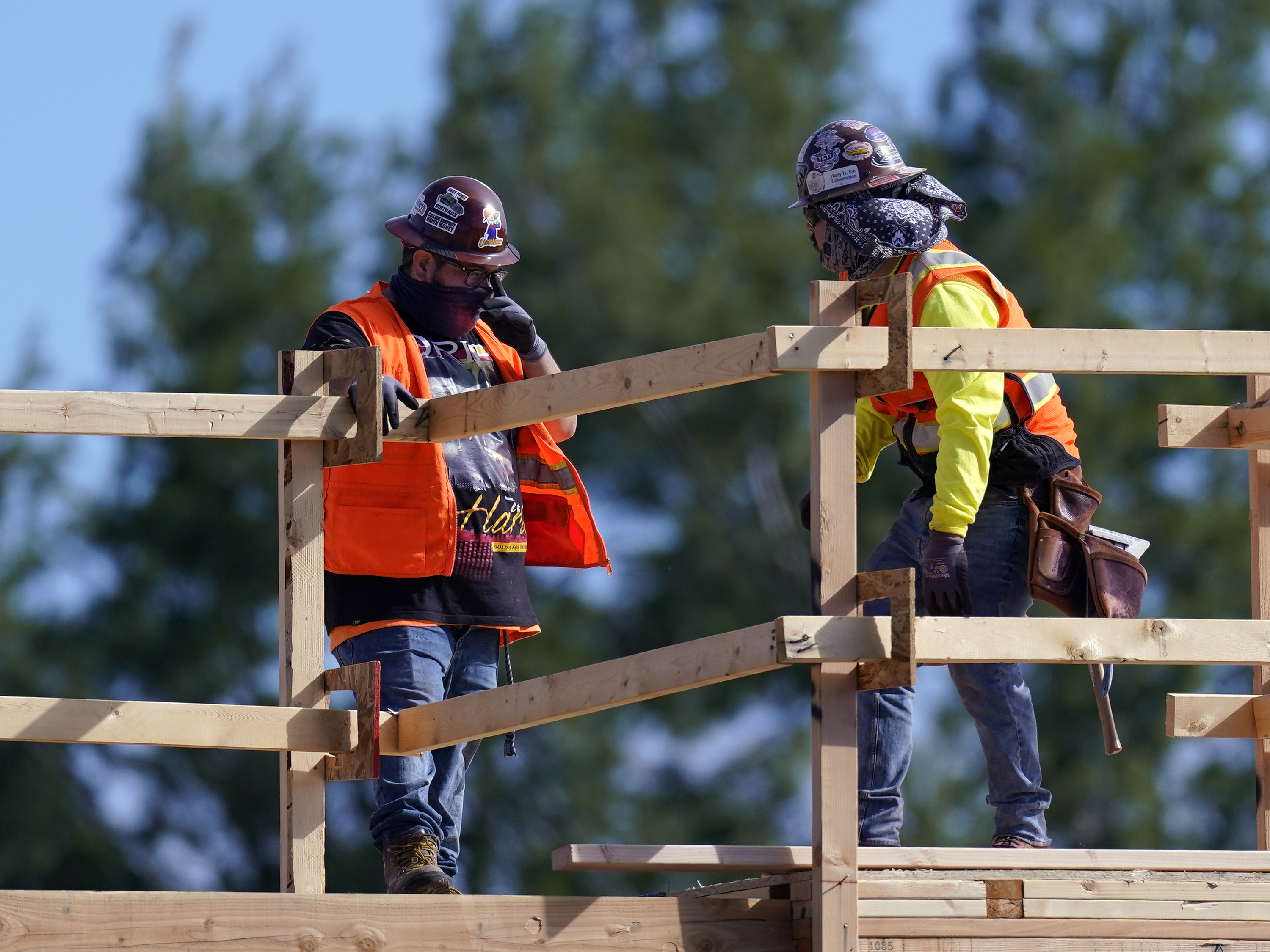 caption: Construction workers at a site in Simi Valley, Calif., on Feb. 2. Nationally, hiring resumed in January although the labor market still has a big hole to climb out of.