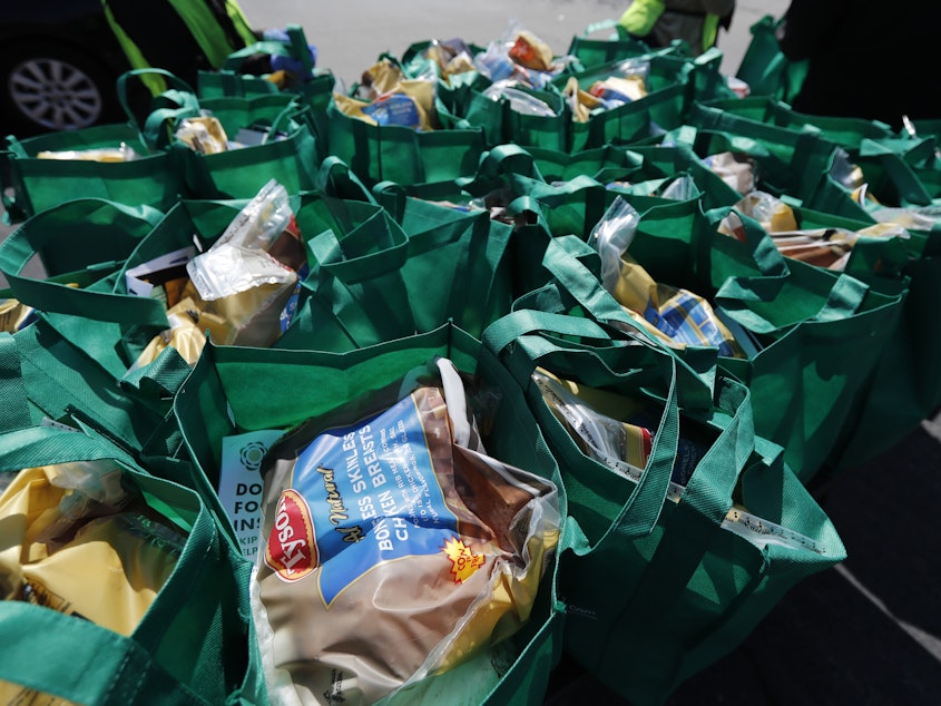 caption: Bags of fresh food wait to be given away in Chicago in May. The number of malnourished people is expected to climb globally, according to the United Nations.