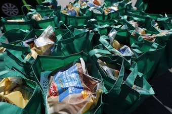 caption: Bags of fresh food wait to be given away in Chicago in May. The number of malnourished people is expected to climb globally, according to the United Nations.