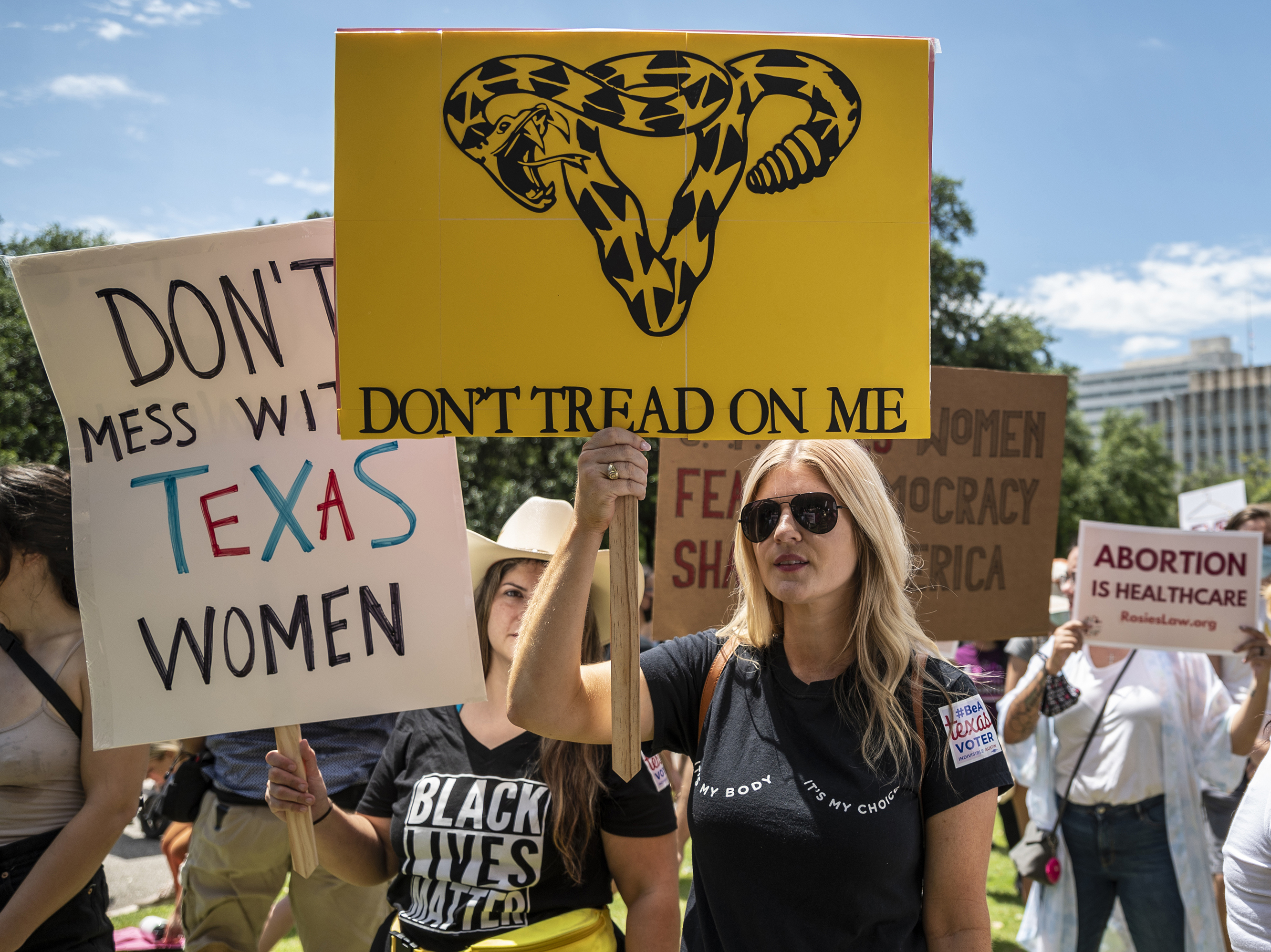 caption: Protesters demonstrate outside the Texas Capitol in Austin in late May in response to a bill that outlaws abortions after a fetal heartbeat is detected.