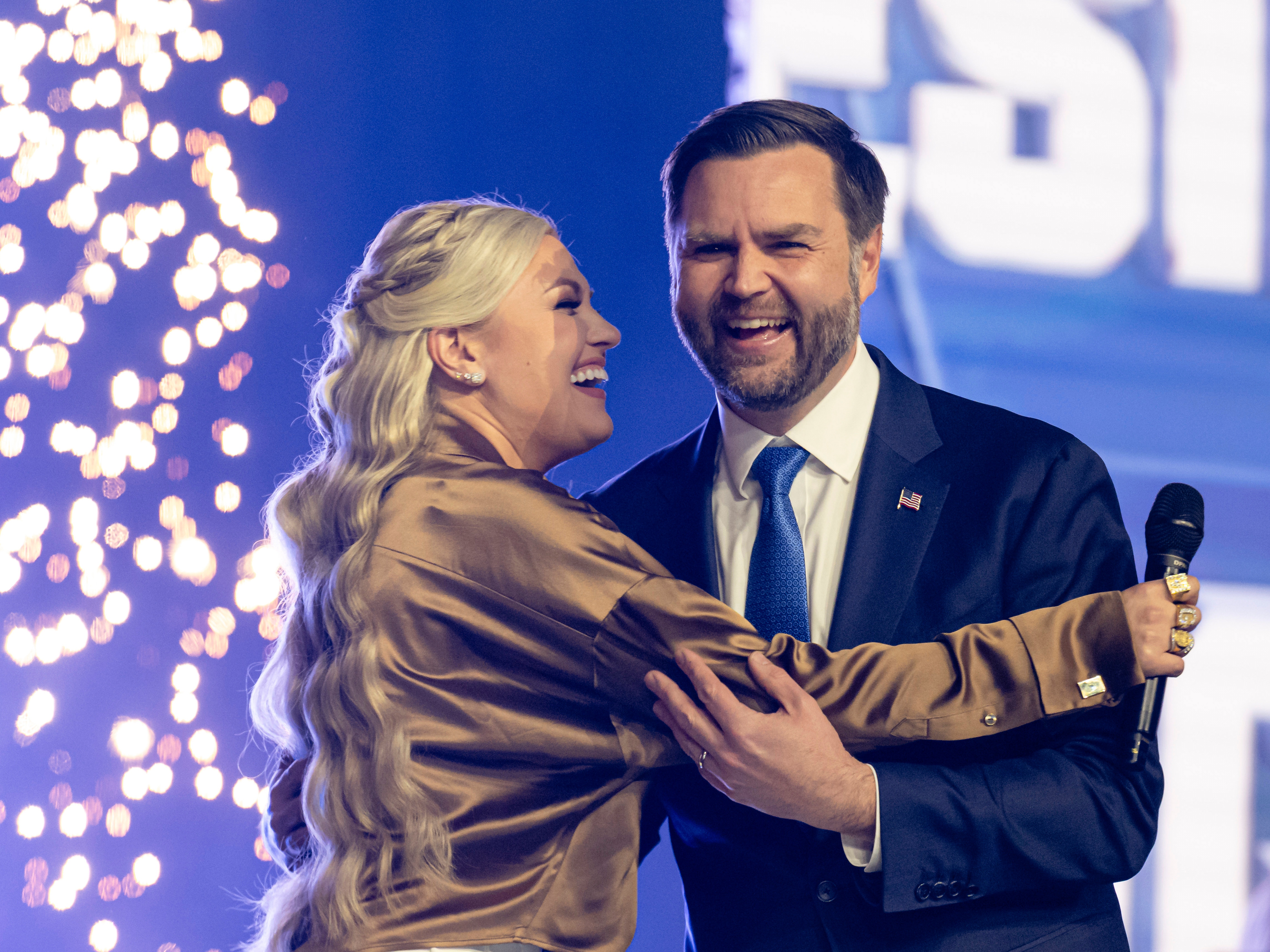 caption: Erika Kirk greets Vice President JD Vance during Turning Point USA's AmericaFest 2025, Sunday, Dec. 21, 2025, in Phoenix.
